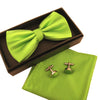 A lime green bow tie and cufflinks set displayed in a brown box and on a matching fabric.