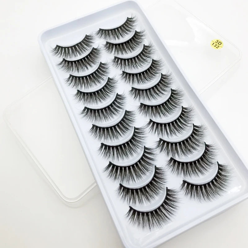 A plastic tray holds a set of dramatic mink false eyelashes for eye makeup.