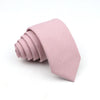 A folded light pink men's tie made of anti-wrinkle bamboo fiber.