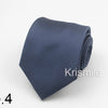 A dark blue necktie with a subtle white dot pattern, folded and displayed on a white background.