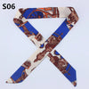 A silk headband scarf featuring a multi-color leopard print design with historical or warrior motifs.
