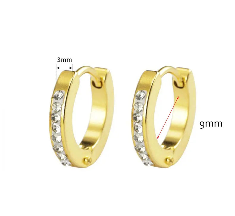 Pair of minimalist gold hoop earrings with small clear stones, shown against a white background.