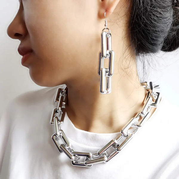 Silver boho punk twisted link necklace worn around the neck and ear.
