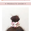 A display of three knitted hair scrunchie headbands in various neutral and floral patterns on a grid background.