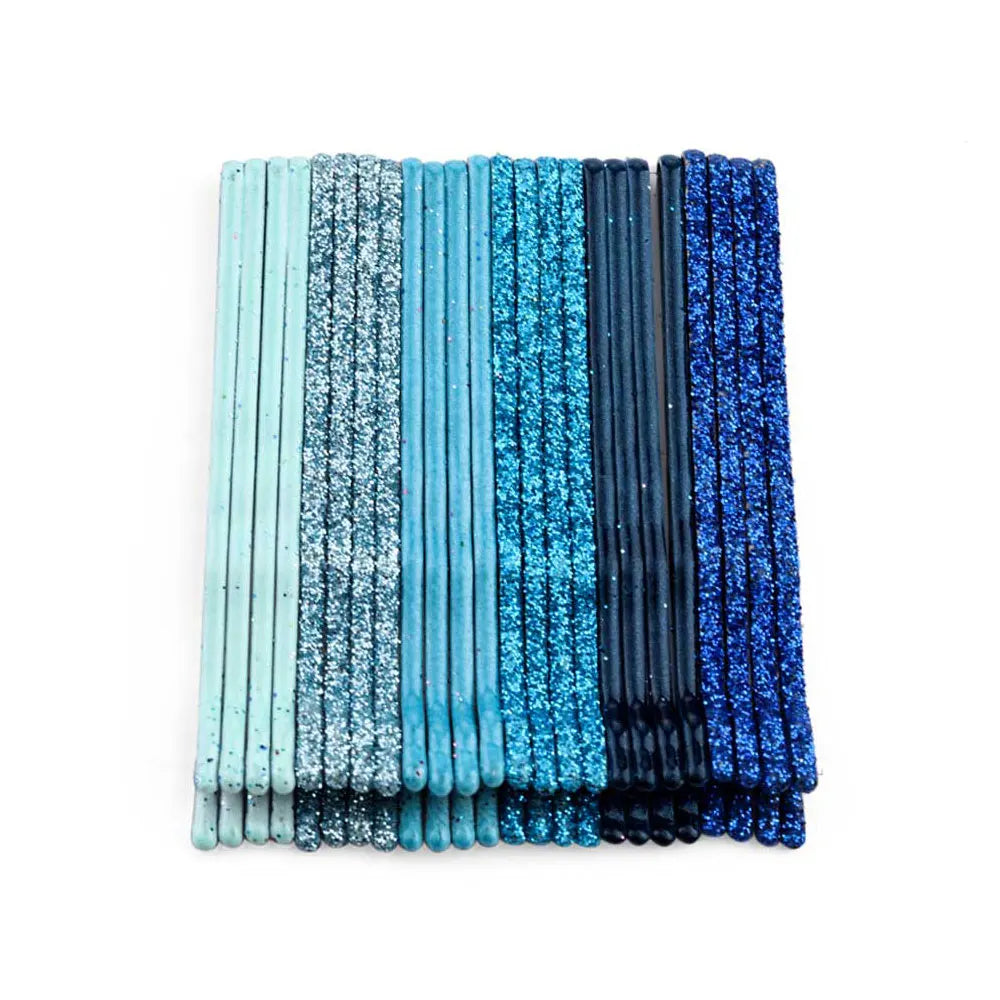 A set of 24 glitter wavy hair clips and bobby pins in various shades of blue and teal.