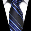 A dark blue and black striped silk jacquard tie tied in a traditional knot, shown against a white shirt collar.