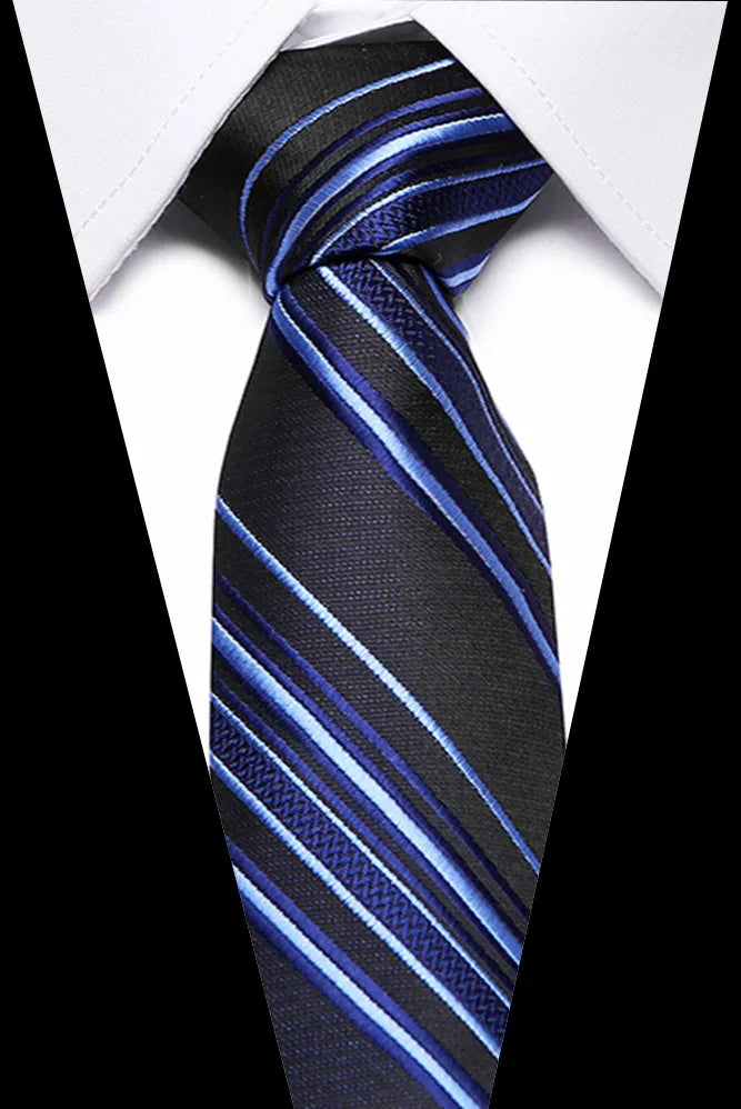 A dark blue and black striped silk jacquard tie tied in a traditional knot, shown against a white shirt collar.