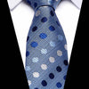 A blue silk jacquard tie with a geometric pattern of silver and blue dots