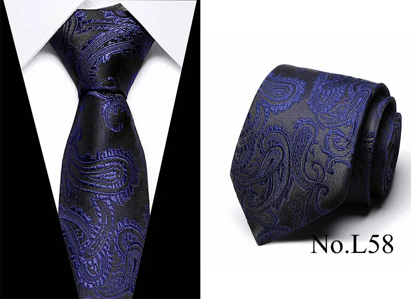 A dark blue silk jacquard tie with an ornate pattern shown in a vertical and folded view.