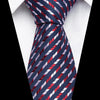 A close-up of a men's silk jacquard tie featuring diagonal stripes in navy blue, red, and white.