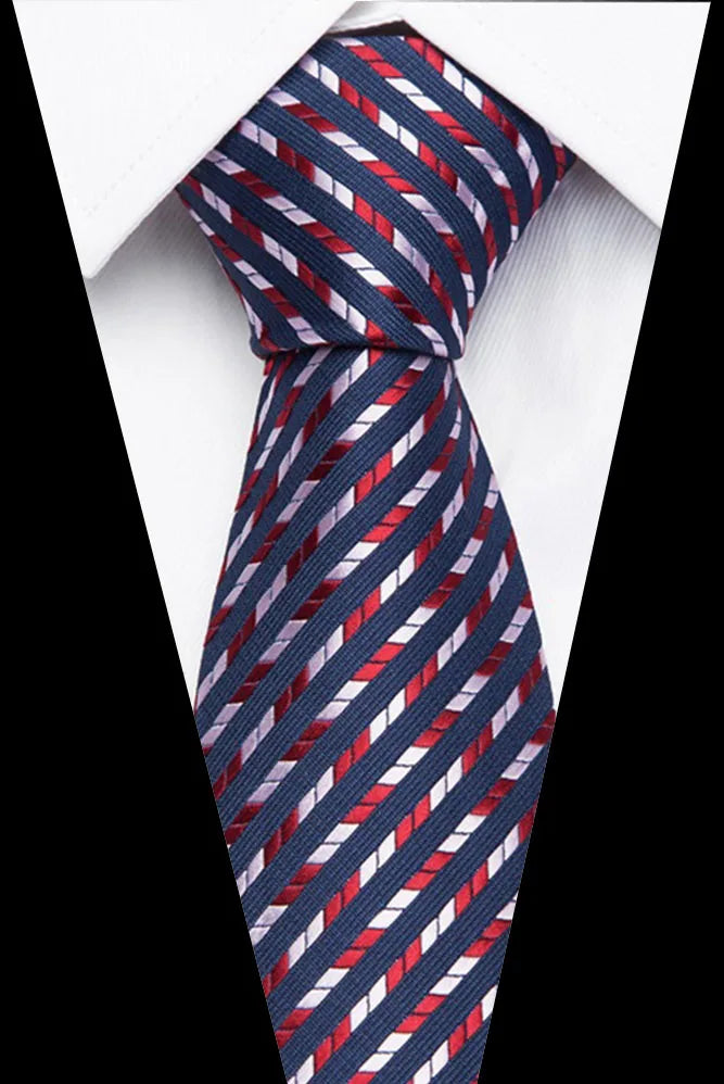 A close-up of a men's silk jacquard tie featuring diagonal stripes in navy blue, red, and white.
