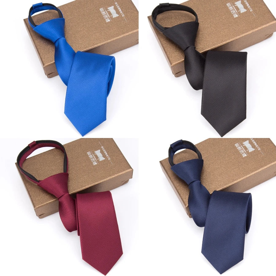 Four ties in blue, black, maroon, and navy colors displayed on cardboard boxes.