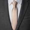 A close-up of a tan striped necktie worn with a gray suit jacket and white shirt.