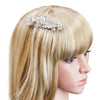 A close-up of blonde hair featuring a silver rhinestone bridal hair comb or tiara accessory.