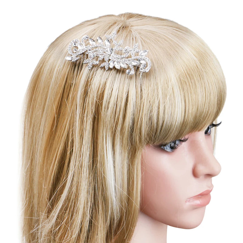 A close-up of blonde hair featuring a silver rhinestone bridal hair comb or tiara accessory.