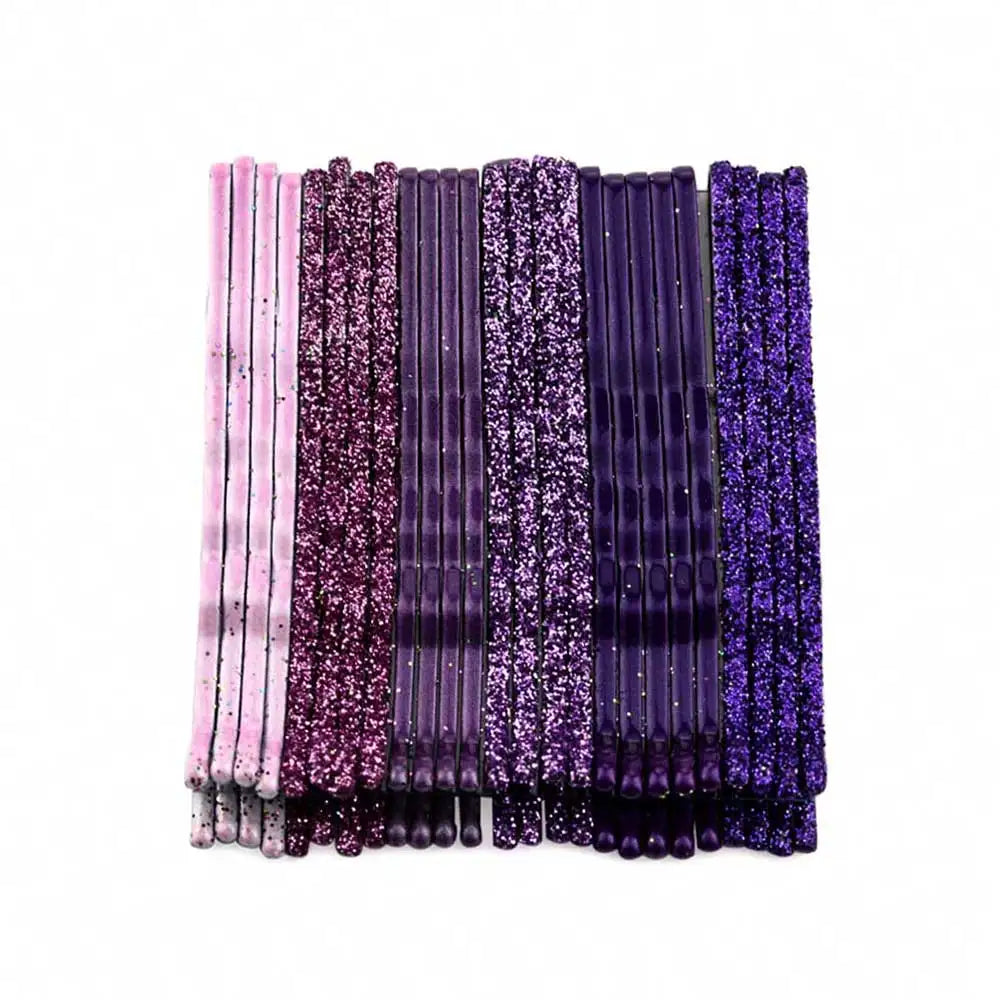 A set of 24 glitter wavy hair clips and bobby pins in various shades of purple and pink.