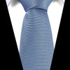 Close-up of a blue patterned silk tie tied in a knot against a white shirt background.