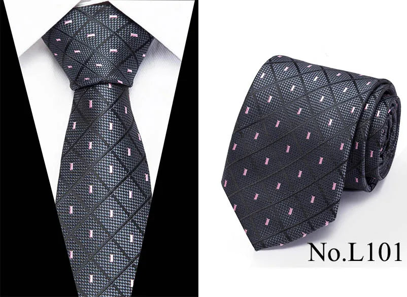 Black silk jacquard tie with a subtle pink pattern shown folded and laid flat.