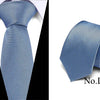 A close-up view of a blue patterned silk jacquard tie folded neatly.