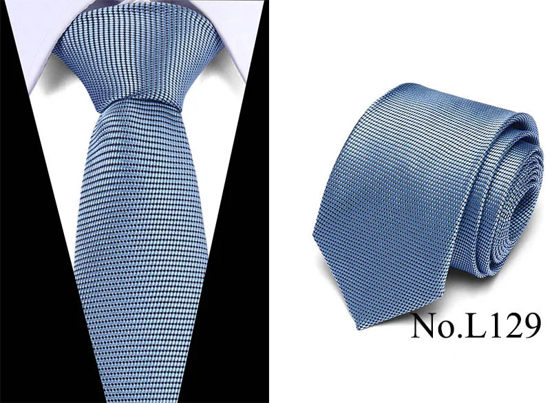 A close-up view of a blue patterned silk jacquard tie folded neatly.