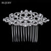 A sparkling silver rhinestone bridal hair comb tiara with long strands
