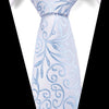 Light blue silk jacquard tie with swirling floral patterns worn against a white shirt.