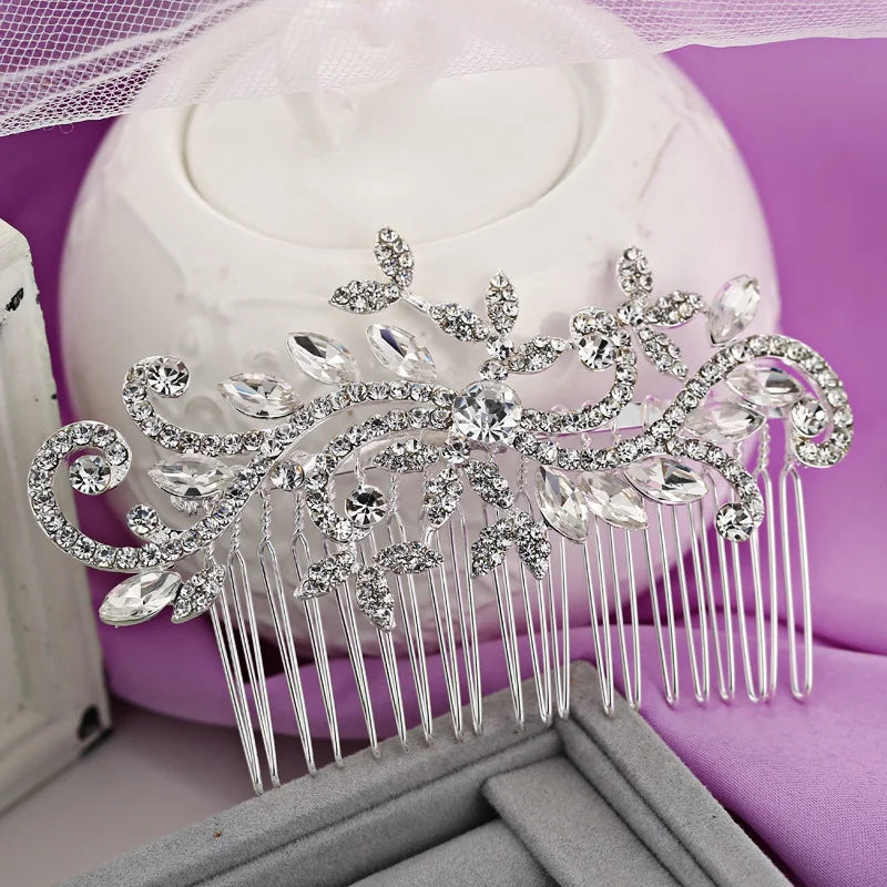 A silver rhinestone bridal hair comb tiara displayed on a purple velvet background.