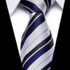 A close-up of a men's silk jacquard tie featuring diagonal stripes in navy blue, gray, and white.