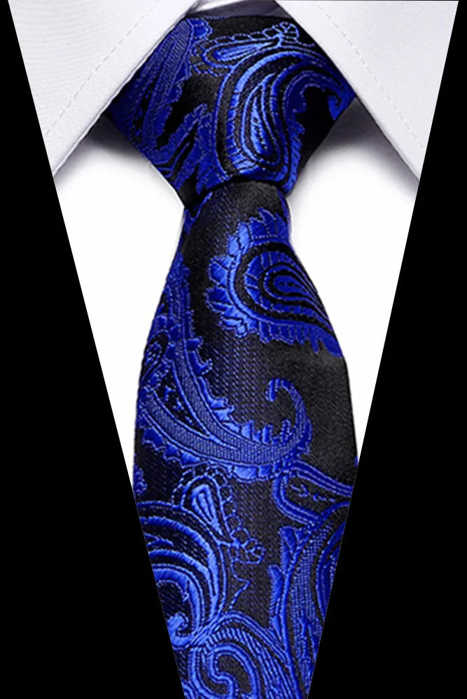 A close-up of a men's silk jacquard tie in royal blue and black paisley pattern worn against a white shirt.
