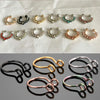 A collection of faux septum nose ring hoops in various sizes and accents, including gold, silver, and colored stones.