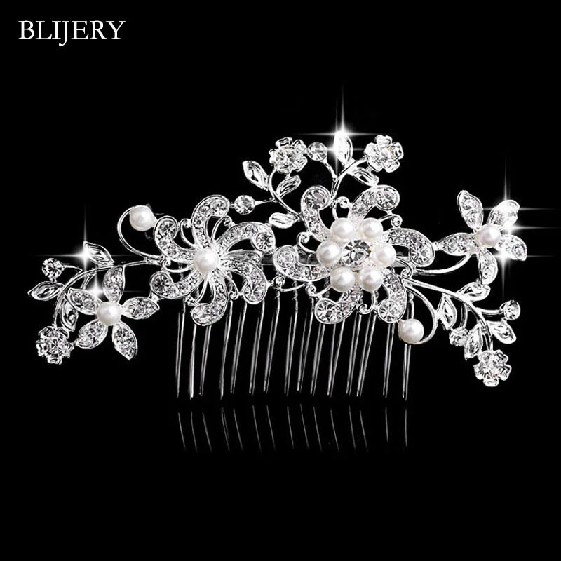 A silver rhinestone bridal hair comb tiara with delicate floral designs and pearls.