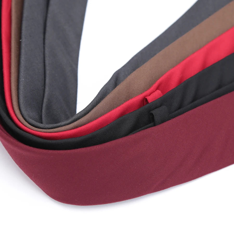 A close-up view of a slim fit wool neck tie in shades of black, brown, and red.
