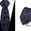 Black silk jacquard tie with blue paisley pattern shown on a white shirt.