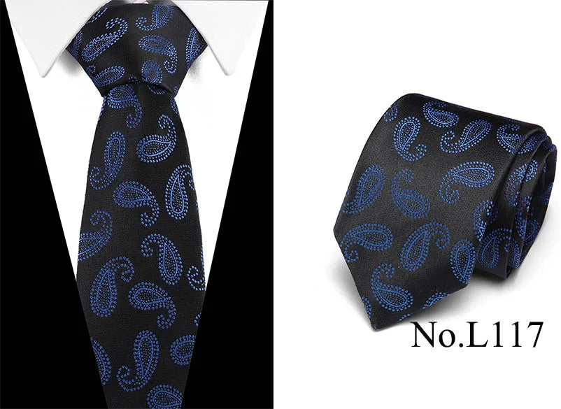 Black silk jacquard tie with blue paisley pattern shown on a white shirt.