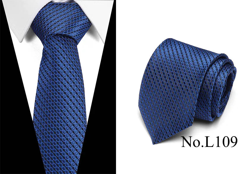 A dark blue silk jacquard tie folded and displayed against a white shirt background.