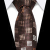 A close-up of a dark brown silk jacquard tie with a repeating geometric pattern against a white shirt.
