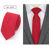 A red slim fit wool neck tie displayed against a gray suit jacket and white shirt.
