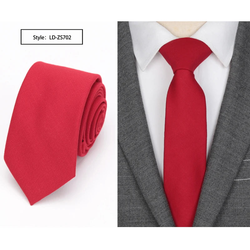 A red slim fit wool neck tie displayed against a gray suit jacket and white shirt.