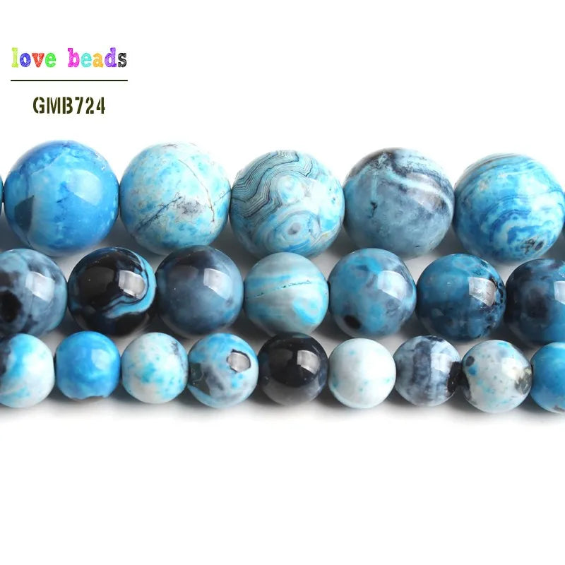 A row of polished sky blue and blue-green agate spacer beads for DIY jewelry.