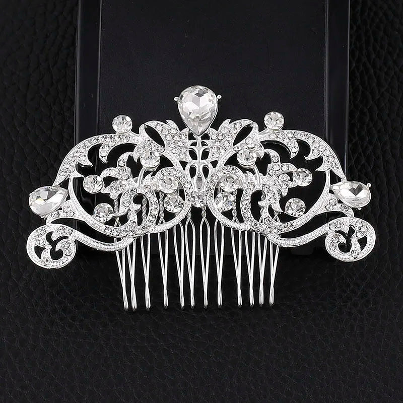 A silver rhinestone bridal hair comb tiara featuring intricate floral designs and a central gemstone.