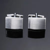 A pair of silver men's classic square cufflink cufflinks displayed against a dark gray background.
