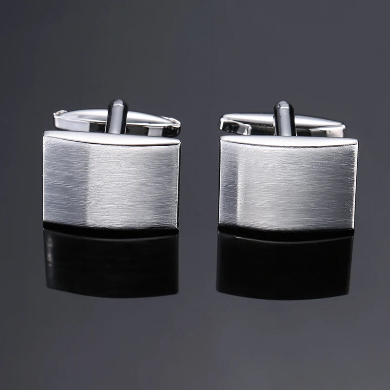 A pair of silver men's classic square cufflink cufflinks displayed against a dark gray background.