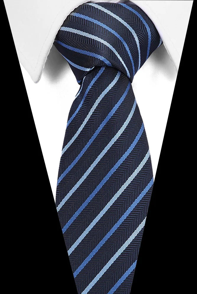 A dark blue striped silk jacquard tie worn with a white dress shirt.