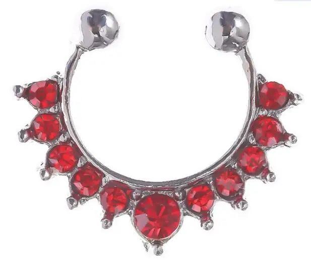 A silver hoop nose ring with red stones and a spherical stud accent.