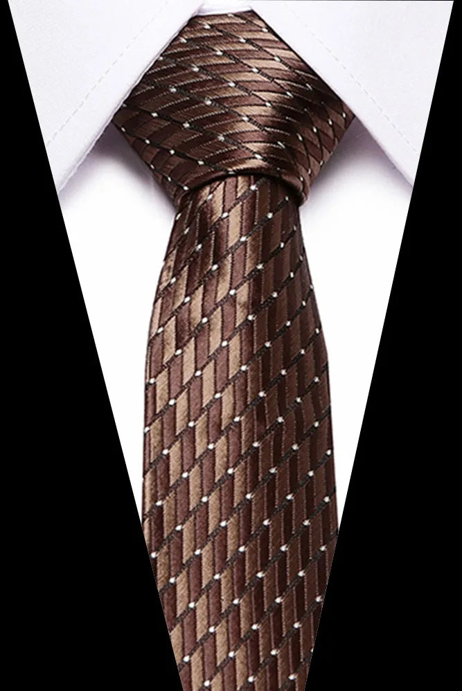A close-up of a dark brown silk jacquard tie tied in a knot against a white shirt.