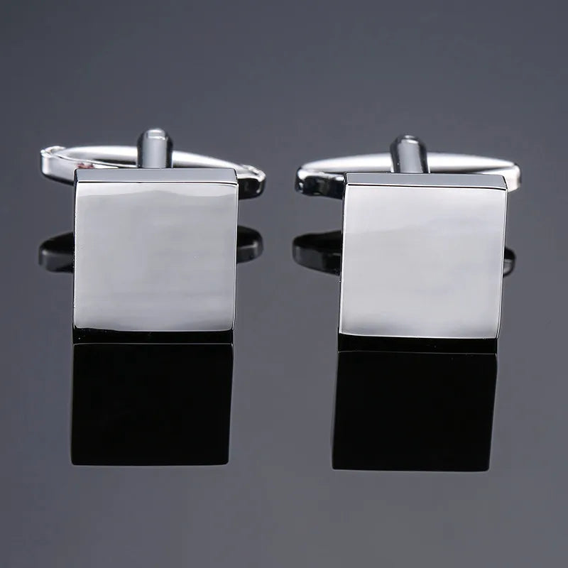 A pair of silver square cufflink holders with a metal bar and a square plate.