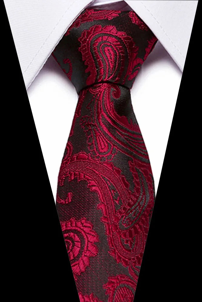 A close-up of a men's silk jacquard tie in deep red and black paisley pattern against a white shirt.