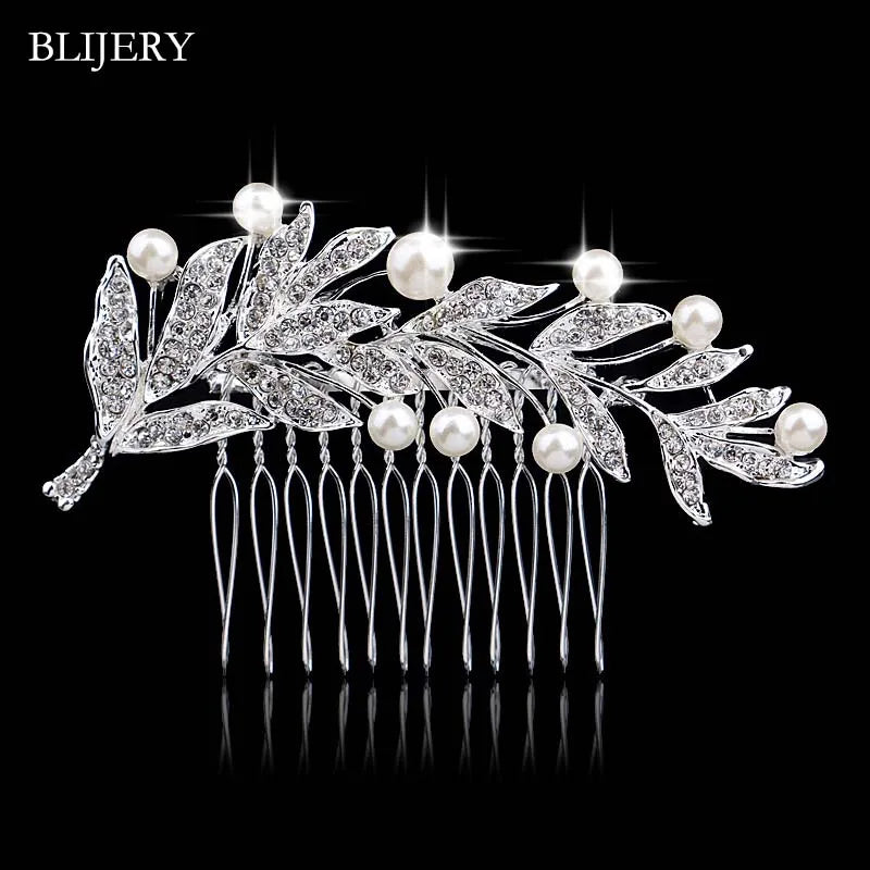 A delicate silver rhinestone bridal hair comb tiara featuring pearls and leafy accents.