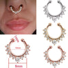 A set of faux septum nose rings in rose gold and silver tones with zircon accents shown against a skin background.