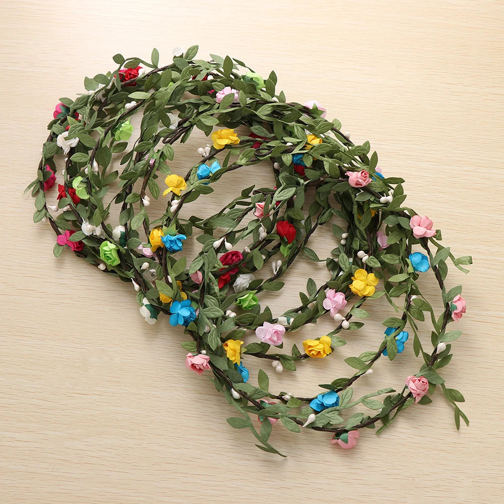 A green floral wreath or garland made of small, colorful fabric flowers used as a bohemian hair accessory.
